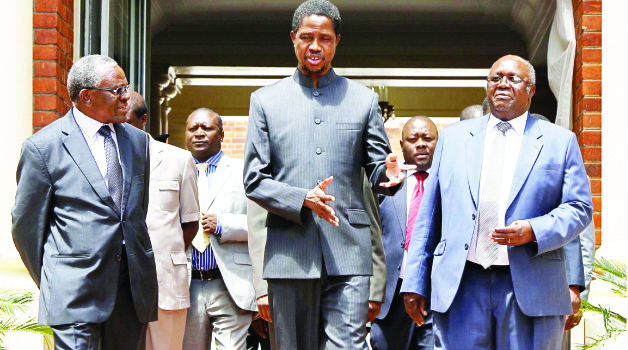 • PRESIDENT Edgar Lungu (centre) talks to retired judge Frederick Chomba (left) and former Chief Justice Matthew Ngulube (right) after they presented tribunal reports to him at State House yesterday. PICTURE BY SALIM HENRY/STATE HOUSE.