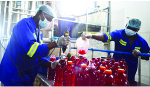 •Workers at Wanzana Processing Company in Lusaka processing drinks, this was when officers from the Citizen Economic Empowerment Commission (not in picture) visited the plant to assess how recipients of loans are operating. Picture by KENNEDY MUPESENI