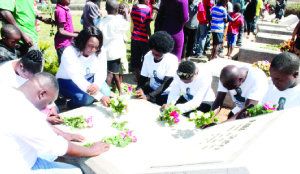 • FAMILY members of late national soccer team defender John Soko laying wreaths at his grave during yesterday’s memorial to mark 22-years of the 1993 Gabon Air disaster.