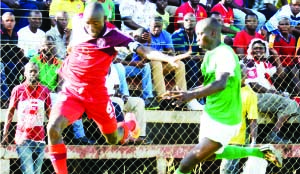 • NKANA midfielder Donashano Malama (left) tries to go past National Assembly defender Matthews Njovu during their Super League match played at Woodlands stadium in Lusaka yesterday. Picture by CLEVER ZULU.