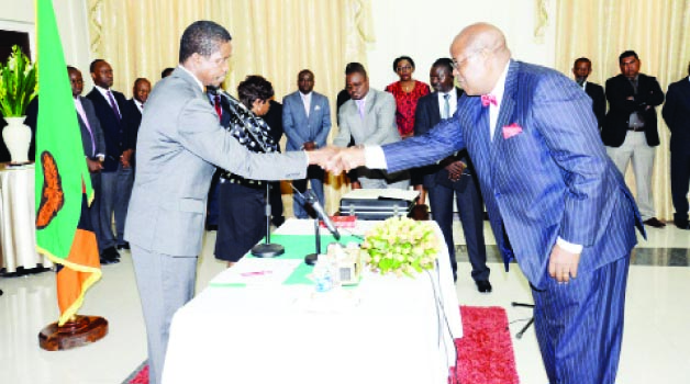 • PRESIDENT Edgar Lungu congratulates Southern Province permanent Secretary Sibanze Simuchoba (above right) after he was sworn-in at State House yesterday. Picture by CLEVER ZULU