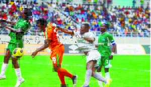 • MUFULIRA Wanderers goalkeeper, Mulife Sitali (second right) fails to punch away the ball as Zesco United defender, Odhiambo Owino (second left) powers home a header during Sunday’s MTN Premier Division League Week Four match at the Levy Mwanawasa Stadium in Ndola. Zesco won 4-1. Picture by KASUMPA KATAPA
