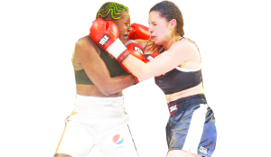 • ZAMBIA’S Esther Phiri (left) trades blows with Sandra Almeida of South Africa during the Women’s International Boxing Association and World Boxing Federation welterweight unification title bout in Lusaka on Friday. (Inset) South African referee, Eddie Marshall steps in to stop the fight after Almeida sustained a cut above her right eye. Pictures by CHRISTINE MWAABA and JEAN MANDELA