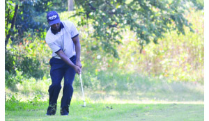 • ZAMBIA’S Madalitso Muthiya blasts out of the rough at the par-five 13th hole after his second shot went wide off the fairway during the third round of the Zambia Sugar Open Championship at Lusaka Golf Club yesterday. Picture by SHAMAOMA MUSONDA