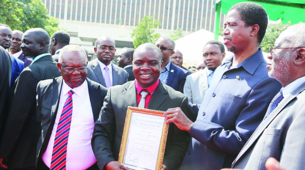 •PRESIDENT Edgar Lungu (right) presents the Presidential award for bravery to Lusaka City Council fire fighter Samuel Jere during Labour Day celebrations in Lusaka yesterday. Picture by EDDIE MWANALEZA