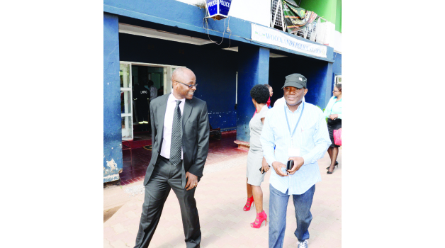 •THE POST Newspaper editor- in- chief Fred M'membe (right) and his lawyer Nchima Nchito leave Woodlands Police station yesterday. Picture by CLEVER ZULU