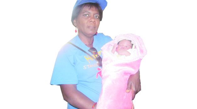 • MWEWOKANI Women’s Organisation chairperson Charity Kalebaika holds baby Joy in the maternity wing at Nchanga North General Hospital in Chingola.