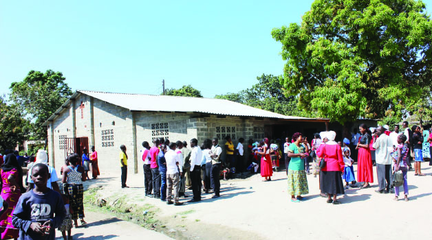 • CONGREGANTS at the United Church of Zambia (UCZ) Ipusukilo in Kitwe outside their church after irate members locked the entrance yesterday. Picture by MAYA NTANDA