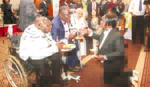 •FIRST Lady Esther Lungu (Kneeling) serves some of the persons living with disabilities during the launch of the Education Outreach for Children with Disabilities in Lusaka yesterday. Picture by THOMAS NSAMA