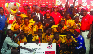 •CHAMPS.....Chizongwe Technical School players and officials display the trophy and a K15,000 dummy cheque after winning the 2015 Copa Coca-Cola Schools soccer championship at the Olympic Youth Development Centre in Lusaka yesterday. Chizongwe beat Chongwe 4-1 in the final. Picture by GWEN CHIPASULA