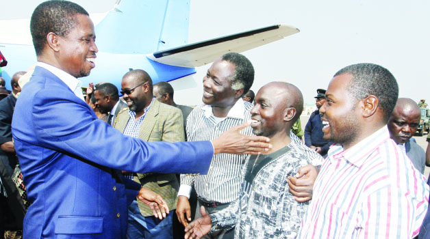 •President Edgar Lungu (left) talks to the Patriotic Front candidate for Solwezi West Constituency Martin Mbaya (second from right) at Solwezi Airport on Friday. Picture By SALIM HENRY/STATE HOUSE