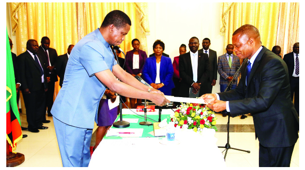 •President Edgar Lungu (left) receives oath of office documents from Transport and Communications Minister Kapembwa Simbao during the swearing ceremony at State House on Thursday, October 8, 2015.Picture by EDDIE MWANALEZA/STATE HOUSE