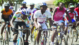 •CYCLISTS vie for honours during the Mazabuka bike race competition. (Inset) Winner Obert Chembe lifted by his supporters and fellow cyclists after winning the race. Picture by GWEN CHIPASULA