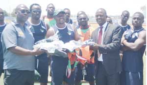 •ZAMBIA Rugby Union (ZRU) president Clement Sinkamba (left) received kit from Mopani Copper Mines public relations manager Nebert Mulenga for use by the national Sevens squad. In the middle is coach Reuben Mkandawire. Picture by GWEN CHIPASULA
