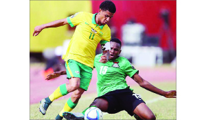 •ZAMBIA’S Paul Katema throws in a challenge to contain South Africa skipper Keagan Dolly during the CAF under-23 Africa cup of Nations Group A match in Dakar on Tuesday. South Africa won 3-2. Picture by BACKPAGE PIX.