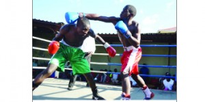 •LEMMY Simbeye (right) of Oriental Quarries Boxing Promotions punishes Jossam Banda  of Mwenya Musenge Boxing Stables during the New Year tournament at Chillers Corner in Kitwe. Picture by SAMUEL LUKHANDA