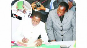 •PRESIDENT Edgar Lungu assents to the amended Constitution at the National Heroes Stadium in Lusaka yesterday, while Chief Justice Ireen Mambilima looks on. Inset, the President shows Zambians the Republican Constitution after assenting to the amended national document.  Pictures by EDDIE MWANALEZA/STATE HOUSE