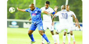• MPUMALANGA Black Aces striker Collins Mbesuma holds off Bidvest Wits defenders during the Absa Premiership game at Bidvets Stadium on Friday. Picture courtesy of SOCCER LADUMA