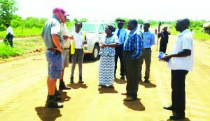 •Raubex project manager Renier Botha (left) listens to Mambwe District Commissioner Caroline Mwanza and Malambo Member of Parliament Jacob Shuma on Mfuwe-Nabwalya Road in Mambwe District yesterday. Picture by JULIUS PHIRI