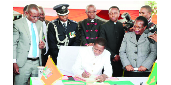 •President Edgar Lungu assents to the Constitution amendment Bill at Heroes Stadium last week. Picture by ZANIS