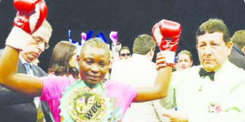 • World Boxing Council (WBC) gold Champion Catherin Phiri celebrates her victory.