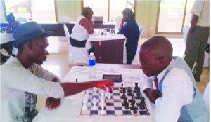 •2014 national champion, Gillian Bwalya (left) makes his move in a seventh-round match against 2015 champion Andrew Kayonde at the ongoing national team selection tournament in Mansa. Picture courtesy of CHESS FEDERATION OF ZAMBIA
