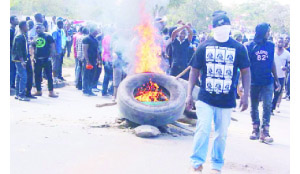 •PROTESTING students at the Copperbelt University burning tyres on the road to express their grievances.