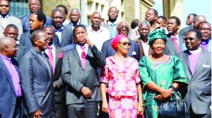 • President Edgar Lungu (third from left) talks to Lusaka Catholic Diocese Archbishop Telesphore Mpundu (second left) as he posed for a photograph with senior Patriotic Front (PF) officials, members of the clergy, opposition party leaders and their representatives at the Anglican Cathedral of the Holy Cross in Lusaka on Tuesday. 