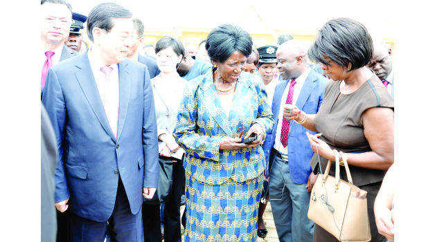 • VICE-President Inonge Wina (centre) confers with Commerce Minister Margaret Mwanakatwe while visiting Chairperson of the Standing Committee of National People’s Congress of China, Zhang Dejiang (left) looks on during a site visit of the Zambia and China Economic and Trade Cooperation Zone in Lusaka East yesterday. Picture by CHILA NAMAIKO