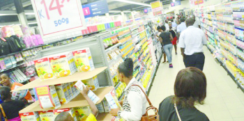 •THE first customers admire goods on promotion at the newly-opened Pick n Pay store in Ndola yesterday. Picture by CHATULA KANGALI