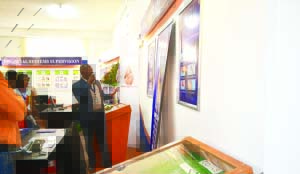 • Bank of Zambia currency account manager Stanley Siame explains how bank notes can be replaced at the central bank’s stand at the show ground in Ndola. Picture by KENNEDY MUPESENI