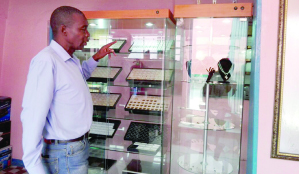 •FESTUS Mbewe checks on some of the stone and jewelry he cuts and polishes at his Festus Fine Jewelry and Gems plant in Ndola. Pictures by CHATULA KANGALI