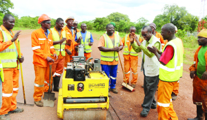 • First Quantum Minerals country manager Kingsley Chinkuli parts company with the road rehabilitation team doing the compaction on the Chingola-Solwezi road after his “tour of duty” on Tuesday. Picture by MARTIN MUSUNKA/SUMA SYSTEMS.