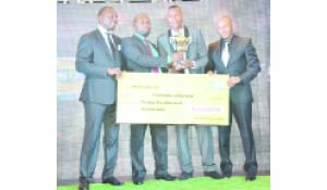 •FOOTBALLER of the Year Ziyo Tembo (second right) receives his trophy from Sports Minister Moses Mawere as FAZ president Andrew Kamanga (left) and MTN chief executive officer Charles Molapisi (right) display a K25,000 dummy cheque for the Zanaco defender during the 2016 MTN-FAZ Awards Gala Night at Hotel InterContinental in Lusaka on Tuesday. Picture by GWEN CHIPASULA