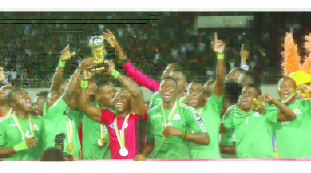 • JUBILANT under-20 players hoist the AFCON trophy after they beat Senegal at National Heroes Stadium in Lusaka yesterday. Picture by JEAN MANDELA