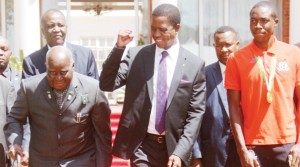 CELEBRATIONS continue - PRESIDENT Edgar Lungu gestures to former President Kenneth Kaunda (left), with Zambia Under-20 playmaker Enock Mwepu (right), at State House in Lusaka, when the Head of State hosted the team for a luncheon yesterday. Picture by JEAN MANDELA
