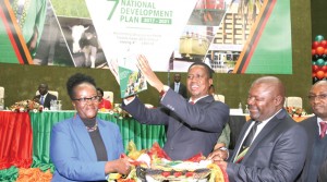 • Man with a Plan: PRESIDENT Edgar Lungu hoists the Seventh National Development Plan document during the launch at the Mulungushi International Conference Center in Lusaka yesterday. Picture by EDDIE MWANALEZA