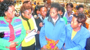  MINISTER of Labour Joyce Simukoko talks to Eves Hair Production workers during the inspection of the Eve's factory in Lusaka yesterday. Picture by JOSEPHENE NSULULU/ZANIS