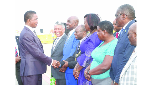 • PRESIDENT Edgar Lungu is welcomed by Lusaka Mayor Wilson Kalumba at Kenneth Kaunda International Airport yesterday shortly after his arrival from the United Nations Annual General Assembly, as Justice Minister Given Lubinda (second left), Lusaka Province Minister Japhen Mwakalombe (third left) and Tourism Minister Charles Banda (far right) look on. Picture by ROYD SIBAJENE/ZANIS