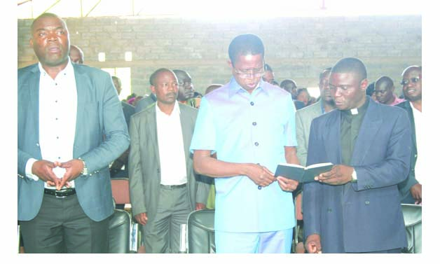 • PRESIDENT Edgar Lungu shares a hymn book with Reverend Adamson Shamfuti during a church service at Mpongwe Baptist Church yesterday On the left is Copperbelt Minister Bowman Lusambo. Picture by SHABBY MULOPWE